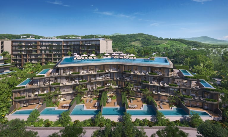 Modern residential complex with curved architecture featuring blue rooftop pools and mountain views in lush green landscape