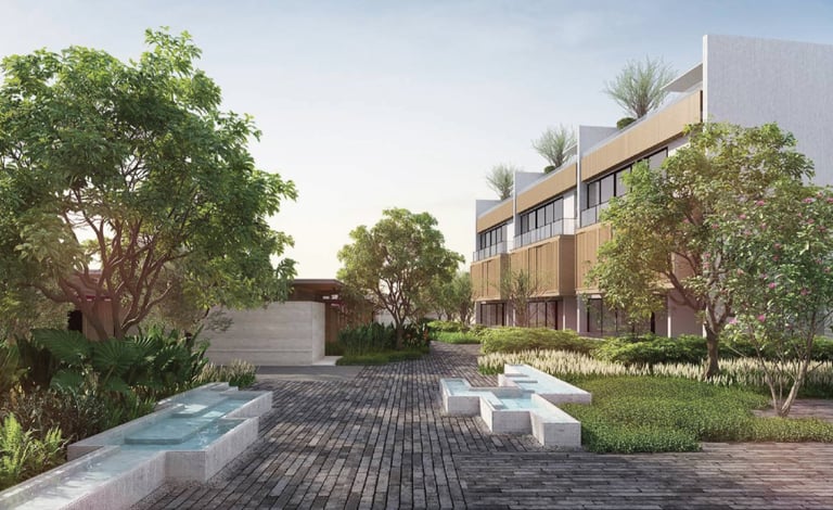 Modern residential courtyard with multi-story building, wooden pathway, landscaping, seating areas, and mature trees