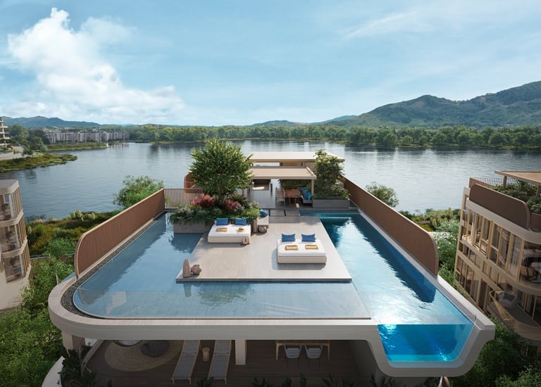 Modern rooftop pool with lounge seating overlooking a river and mountainous landscape