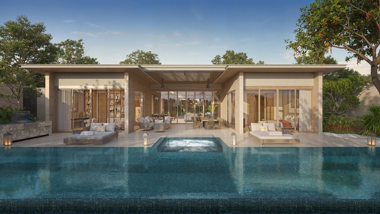 Modern poolside house with glass doors, stone facade, and infinity pool reflecting blue water under clear sky with surrounding trees