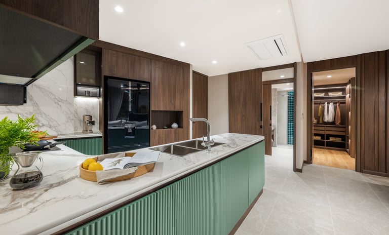 Modern kitchen with green and white island, marble countertops, dark wood cabinetry, and stainless steel appliances