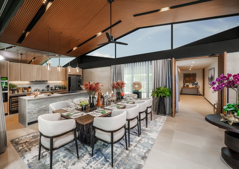 Modern open-concept kitchen and dining area with wood ceiling, dining table, contemporary furniture, and purple flowers