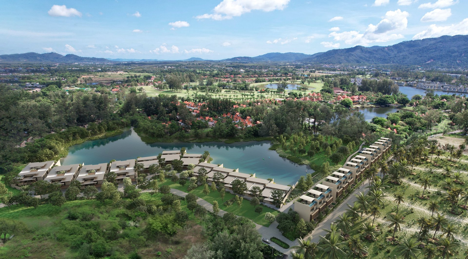 Aerial view of a resort with curved buildings along a river, surrounded by tropical vegetation and mountains in the distance