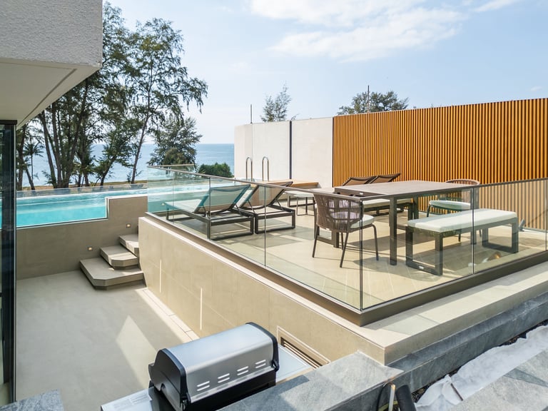 Modern terrace with swimming pool, lounge chairs, dining table, grill, and wooden privacy screen in contemporary residence